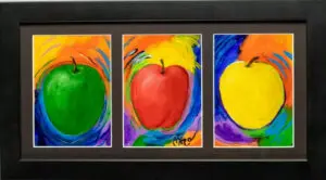 A black framed triptych of a Red, Green, and Yellow apple appearing in each image space.