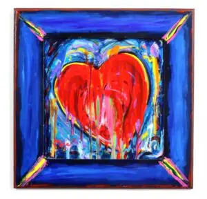 A pop art painting of a red heart surrounded by swirling blues, yellows, and pinks. Color drips down the heart.