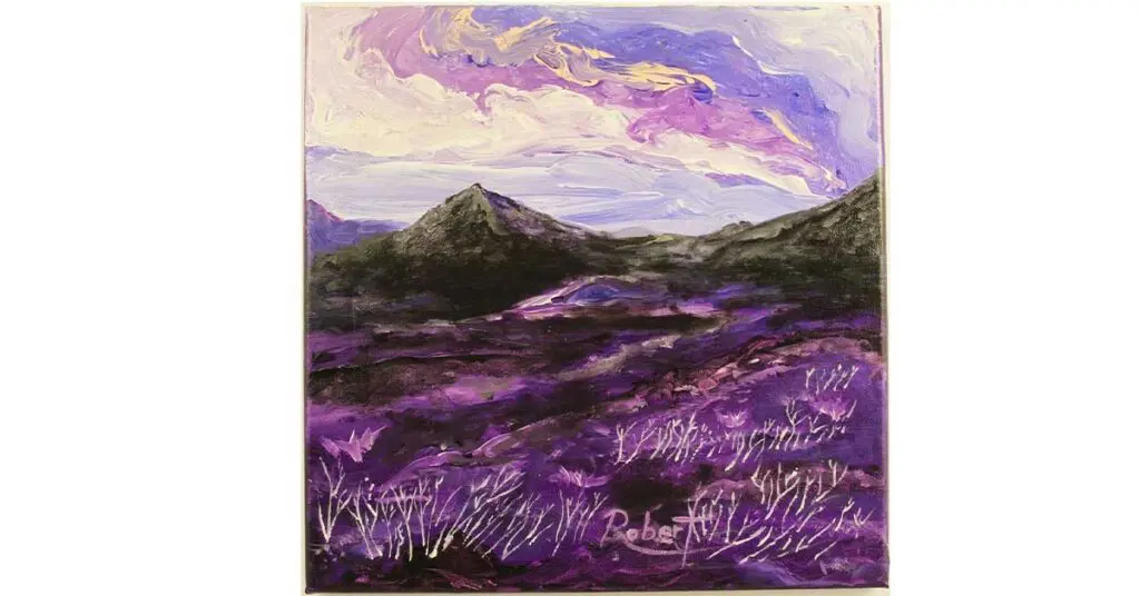 A mountain scene in purple with a pink, purple, and creamy cloudy sky. 